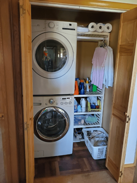 Washer and dryer set up in residential home prior to renovations